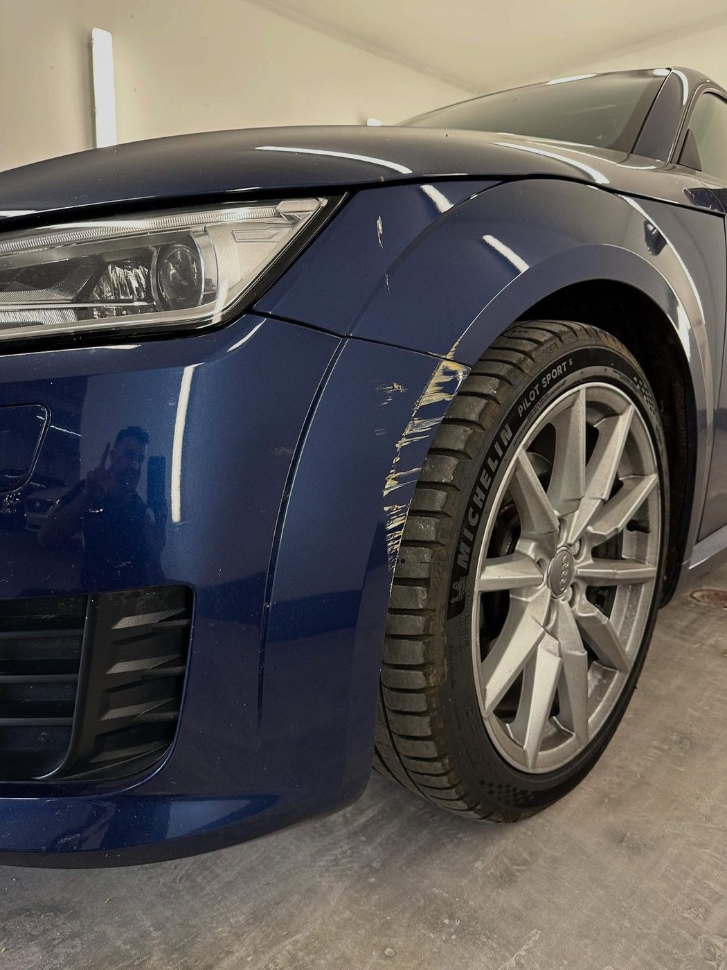 Audi TT front wing with a deep scratch and paint transfer, before repair